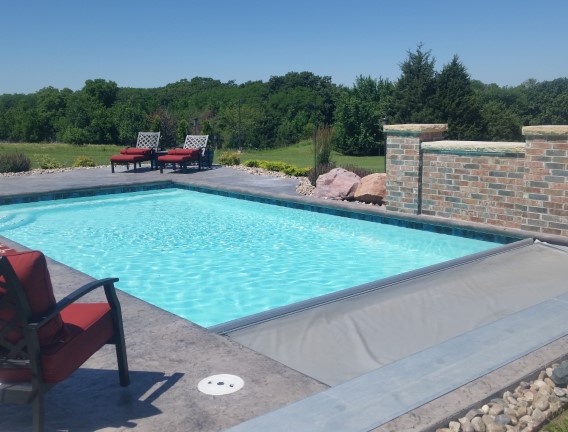 Pool chairs around cool swimming pool - Swimming Pools Service & Repair in Abilene, KS